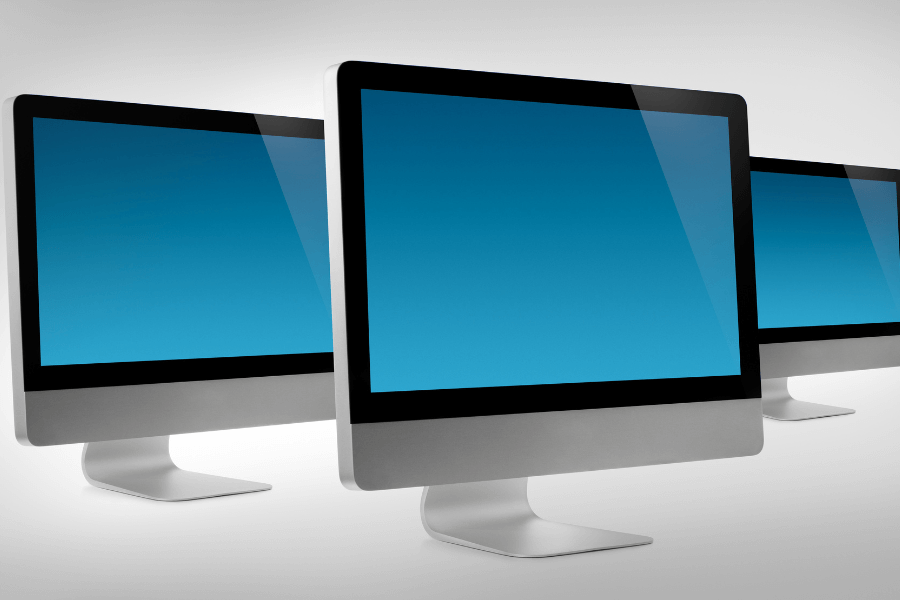 3 desktop computer monitors with blue screens on a white backgrouns placed on a white surface